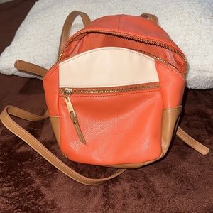 Orange, white and tan small backpack